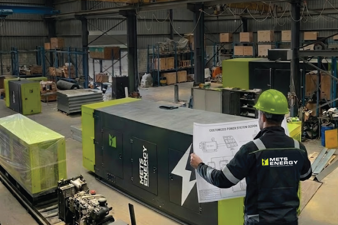 METS Energy engineer reviewing backup power system design next to an industrial generator.
