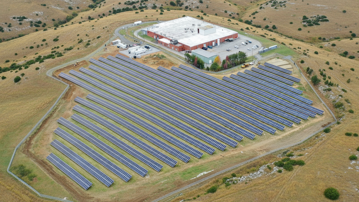an aerial view of a microgrid with a solar farm and power station